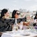 Guests toasting glasses at a picnic table decorated with lavender bouquets at the Aires de Lavanda lavender farm